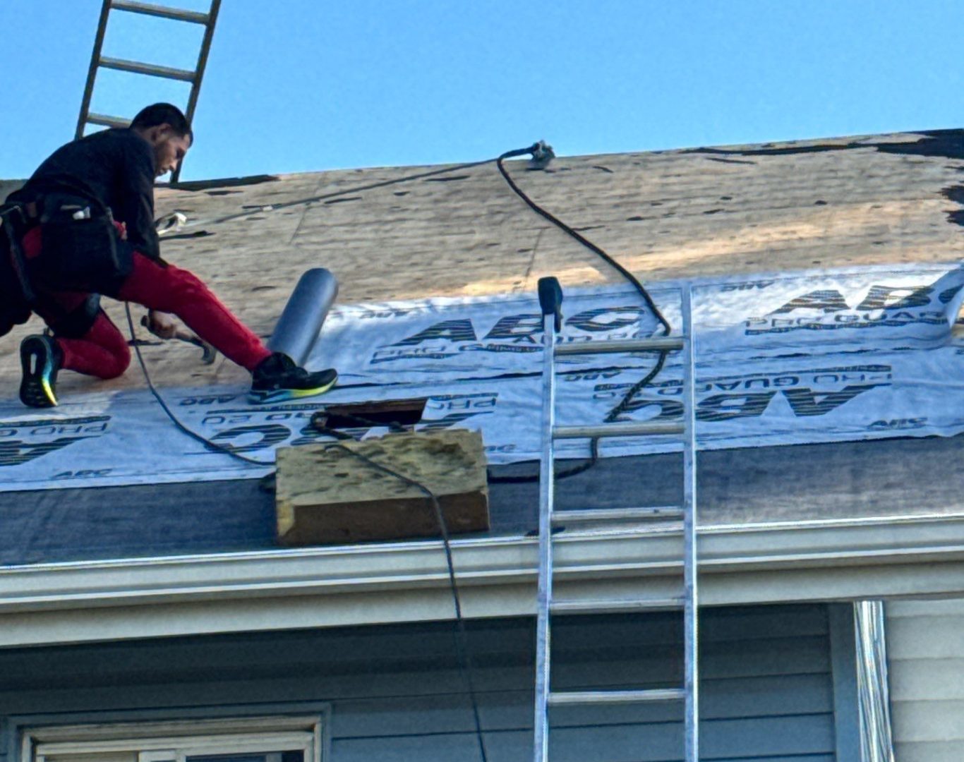 Diamond Roofing Pros working on metal roof