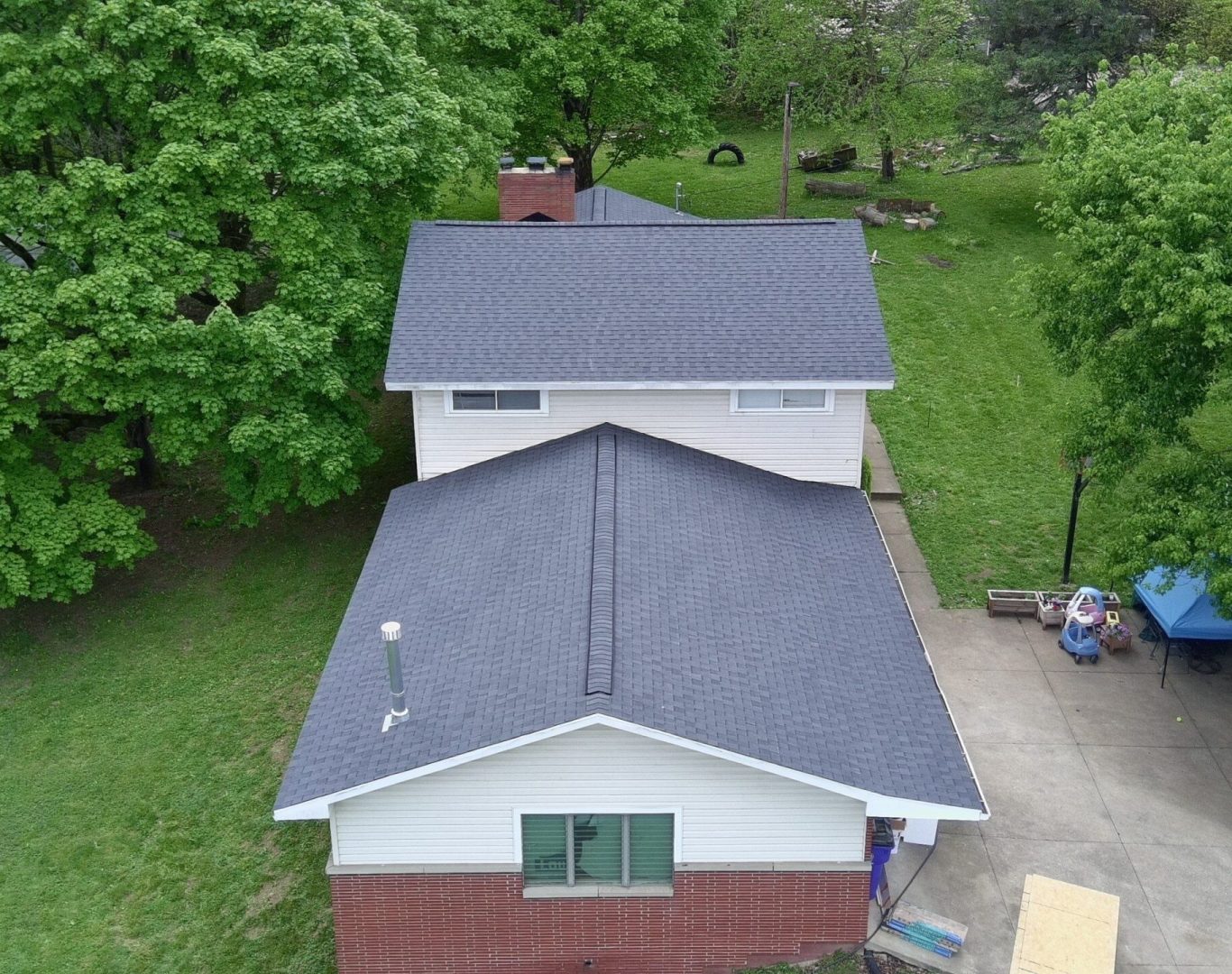 Diamond Roofing Pros worker securing a flashing repair on a chimney.