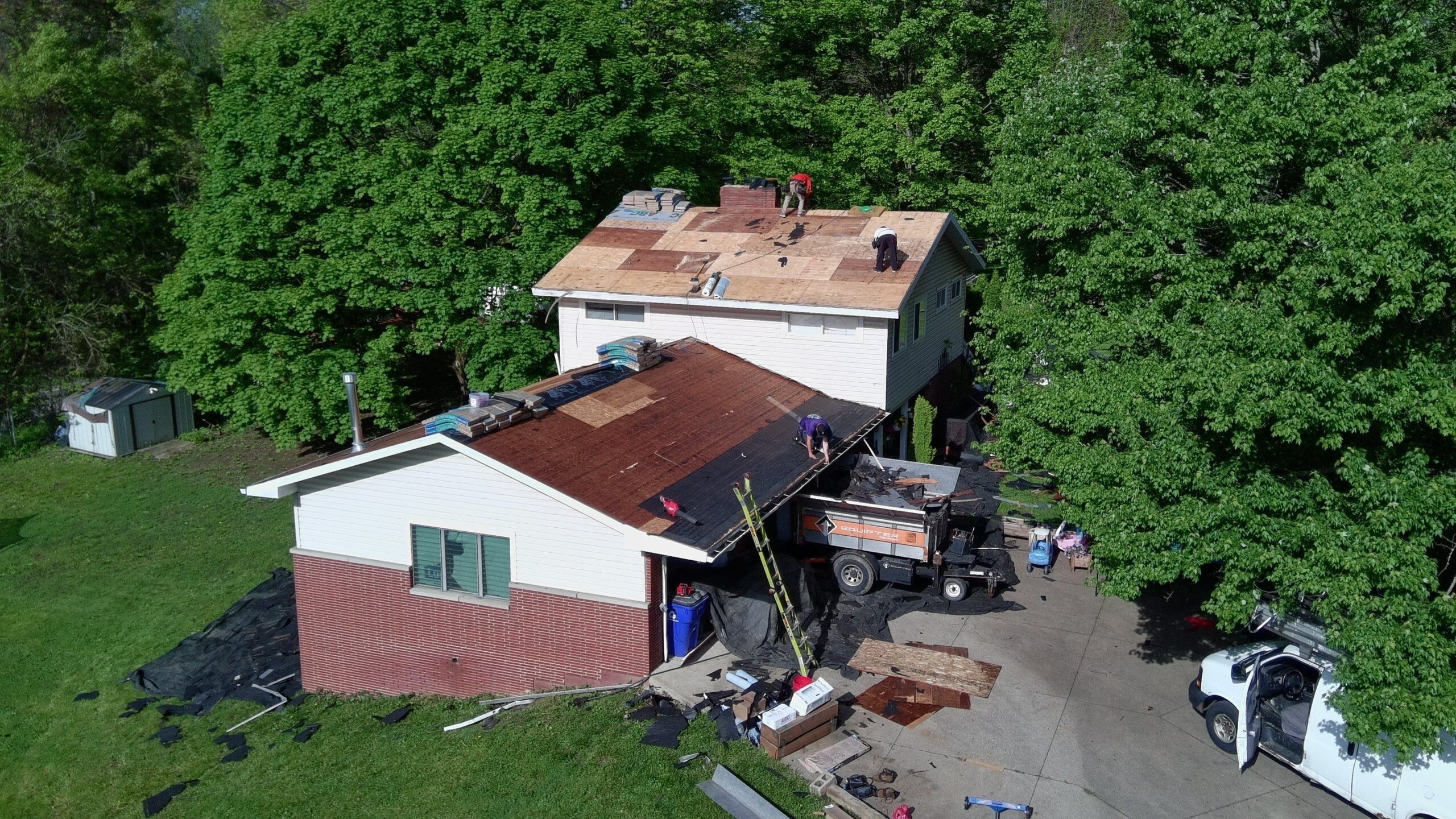 Diamond Roofing Pros using safety harnesses during a high-rise repair.