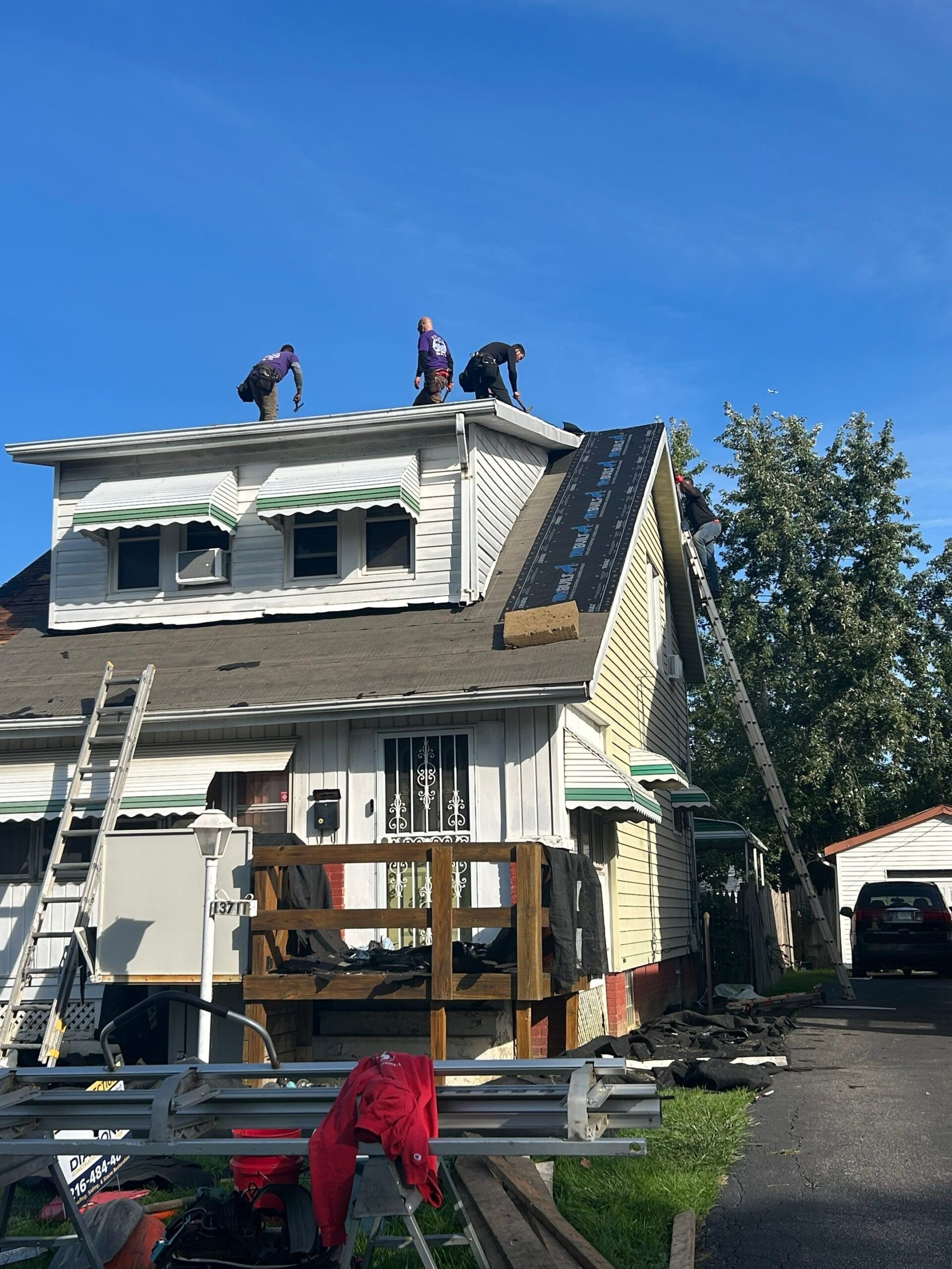 Diamond Roofing Pros van parked while a team is working on a property.